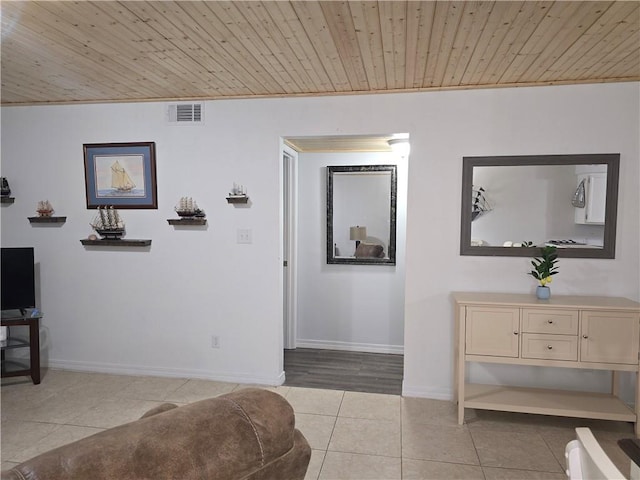 hallway featuring wooden ceiling, ornamental molding, and light hardwood / wood-style flooring