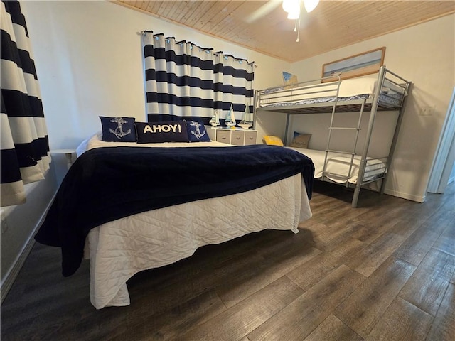 bedroom with ceiling fan, wood ceiling, and dark hardwood / wood-style floors