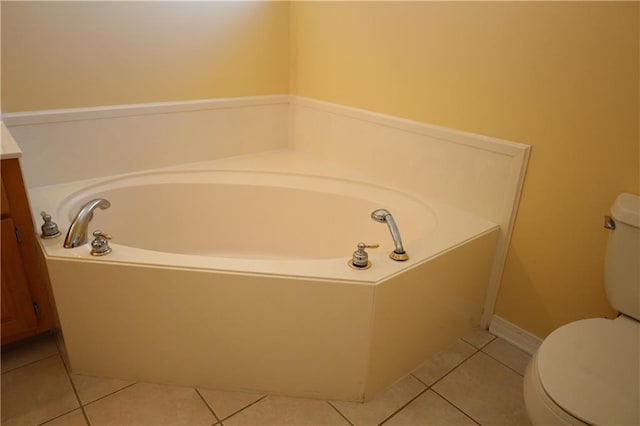 full bathroom featuring tile patterned floors, toilet, a bath, and vanity