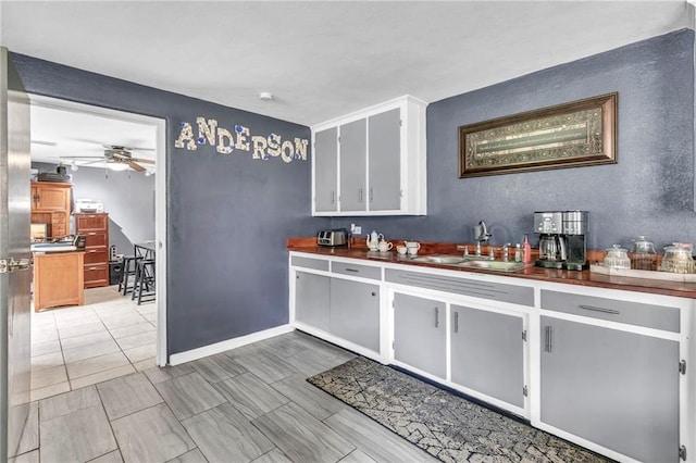 18127 County Road 10th Rd, Foley, AL 36535 - bar with a sink, baseboards, ceiling fan, and a textured wall