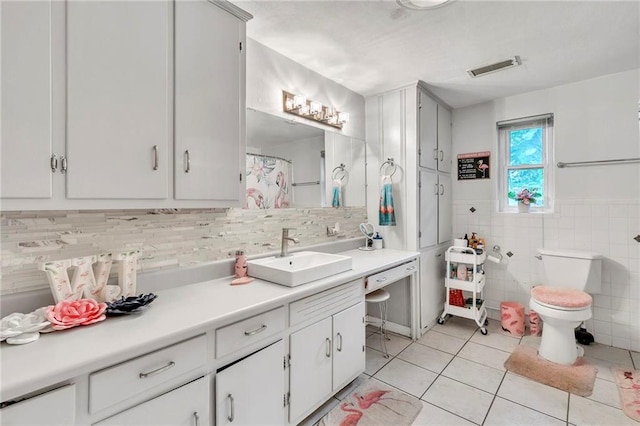 18127 County Road 10th Rd, Foley, AL 36535 - full bath featuring visible vents, tile walls, tile patterned flooring, vanity, and toilet