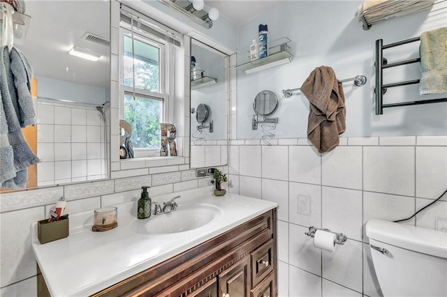 18127 County Road 10th Rd, Foley, AL 36535 - bathroom featuring vanity, radiator heating unit, toilet, and tile walls