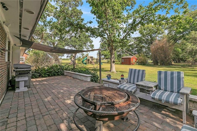 18127 County Road 10th Rd, Foley, AL 36535 - view of patio featuring a playground, an outbuilding, an outdoor fire pit, and a grill