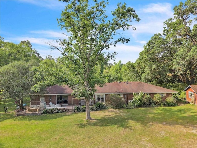 18127 County Road 10th Rd, Foley, AL 36535 - rear view of property with a patio, a yard, and brick siding