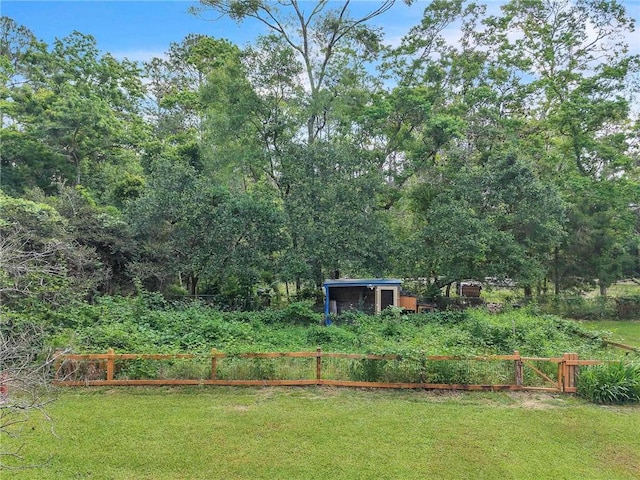 18127 County Road 10th Rd, Foley, AL 36535 - view of yard with fence, a storage unit, an outbuilding, and a forest view