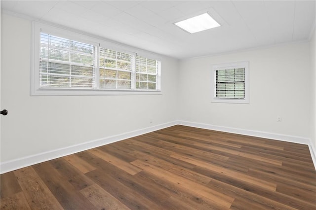 spare room with dark hardwood / wood-style floors and ornamental molding