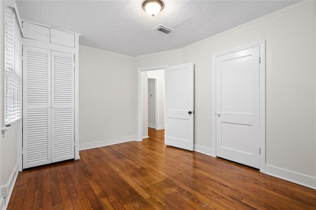 unfurnished bedroom featuring dark hardwood / wood-style flooring and ornamental molding