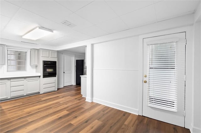 kitchen with hardwood / wood-style flooring and black oven