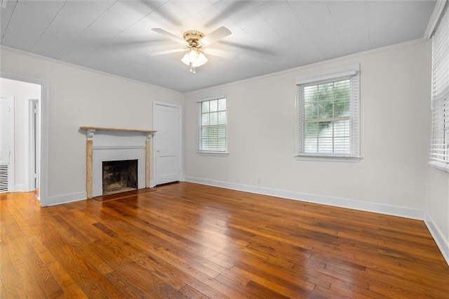 unfurnished living room featuring hardwood / wood-style flooring, ceiling fan, and ornamental molding