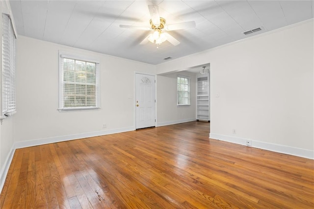 unfurnished room featuring ceiling fan, hardwood / wood-style floors, and ornamental molding