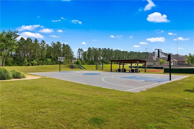 view of sport court with a pergola and a lawn