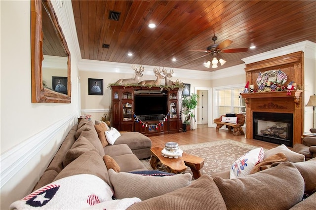 living room with light hardwood / wood-style floors, wood ceiling, ornamental molding, and ceiling fan