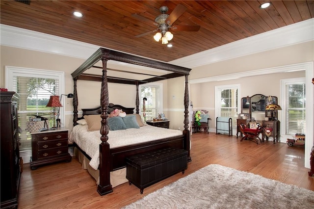 bedroom featuring wooden ceiling, crown molding, and hardwood / wood-style floors