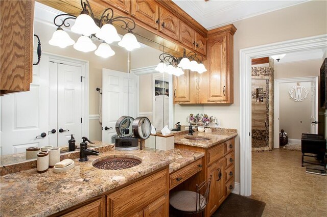 bathroom featuring crown molding, tile patterned floors, and vanity