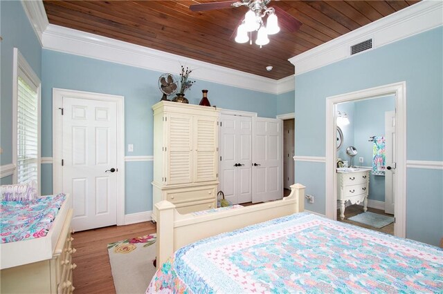 bedroom featuring ornamental molding, wooden ceiling, light hardwood / wood-style floors, connected bathroom, and ceiling fan