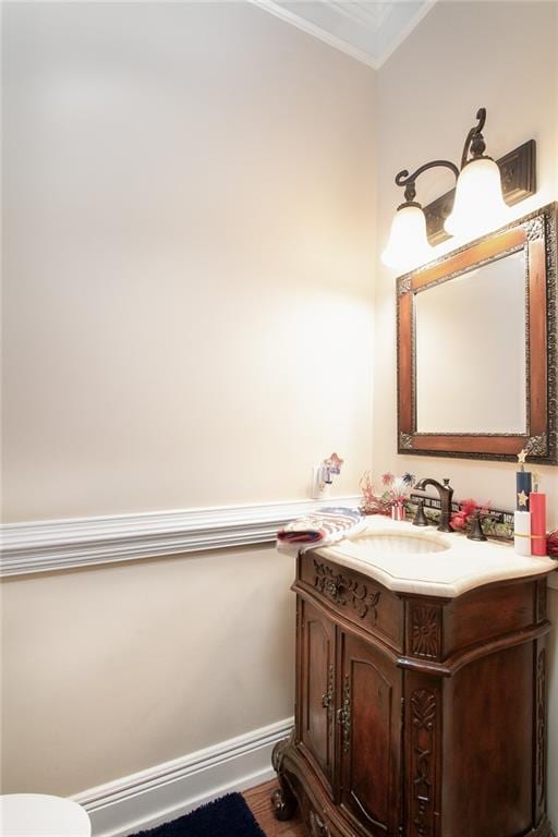 bathroom featuring crown molding, vanity, and hardwood / wood-style floors