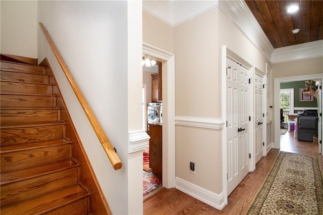 hall with hardwood / wood-style floors and crown molding