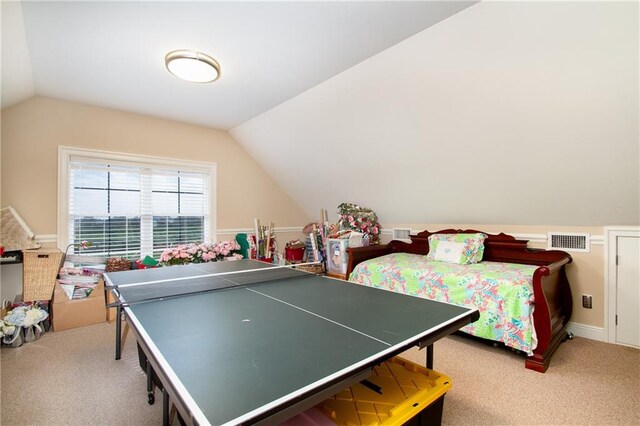 recreation room featuring carpet floors and vaulted ceiling