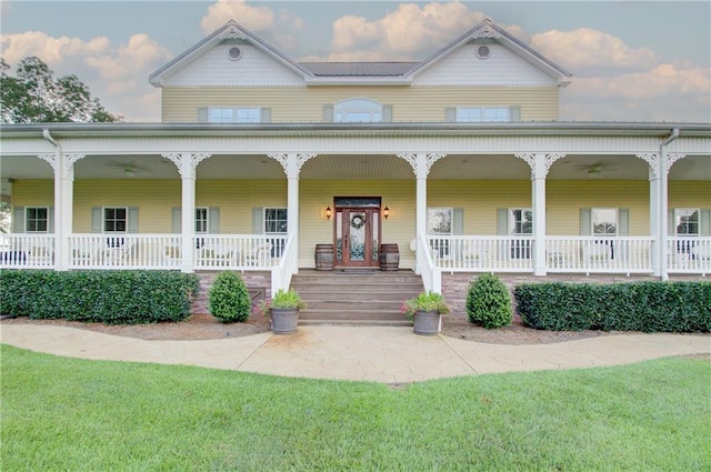 view of front facade with a front lawn and covered porch