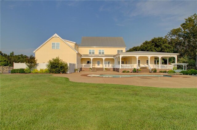 back of house with a patio area and a yard