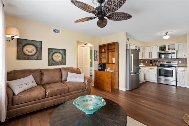 living room with dark hardwood / wood-style floors and ceiling fan