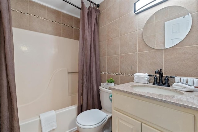 full bathroom featuring shower / bath combination with curtain, tile walls, toilet, and large vanity