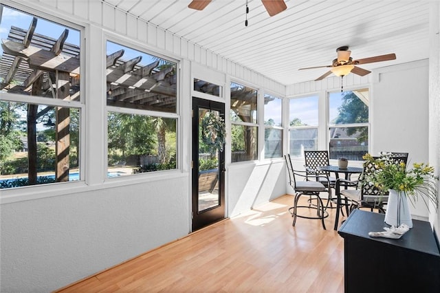 sunroom / solarium with wooden ceiling and ceiling fan