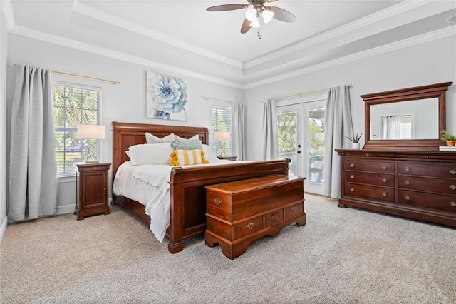 carpeted bedroom featuring french doors, access to exterior, crown molding, a raised ceiling, and ceiling fan