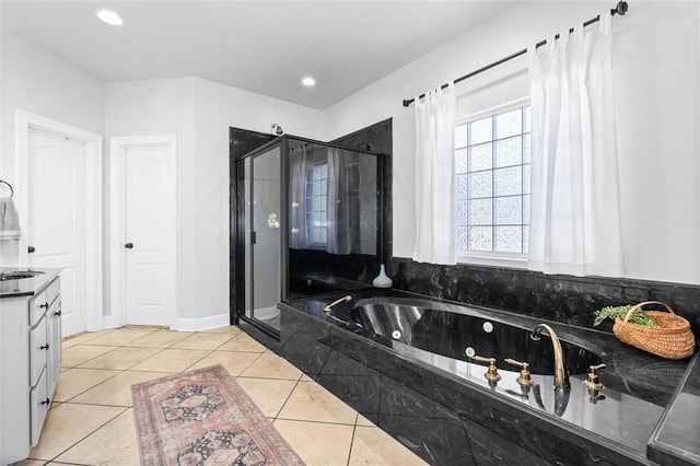 bathroom featuring vanity, independent shower and bath, and tile patterned flooring