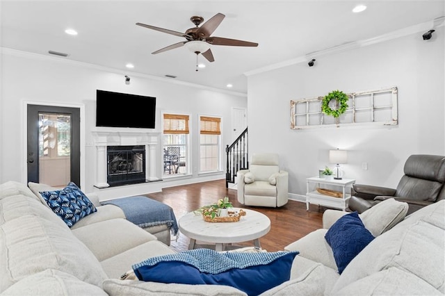 living room featuring ceiling fan, ornamental molding, and hardwood / wood-style floors