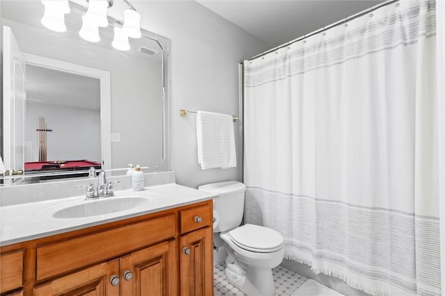 bathroom featuring vanity, toilet, and pool table