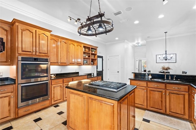 kitchen featuring a kitchen island, hanging light fixtures, stainless steel appliances, sink, and an inviting chandelier