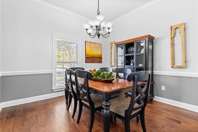 dining space featuring an inviting chandelier, ornamental molding, and dark hardwood / wood-style flooring