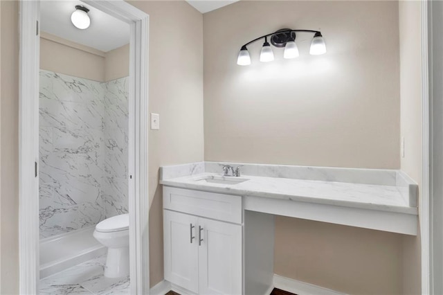 bathroom featuring toilet, tiled shower, and vanity