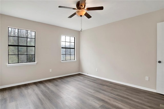 spare room featuring ceiling fan and dark hardwood / wood-style flooring