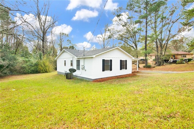 view of side of property with cooling unit and a yard