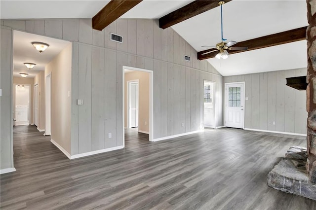 unfurnished living room featuring a stone fireplace, lofted ceiling with beams, ceiling fan, and dark wood-type flooring