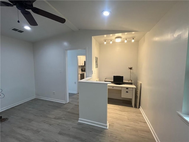 unfurnished office featuring lofted ceiling with beams, baseboards, visible vents, wood finished floors, and ceiling fan