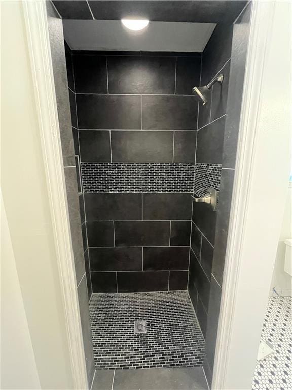 bathroom featuring tile patterned flooring and a stall shower