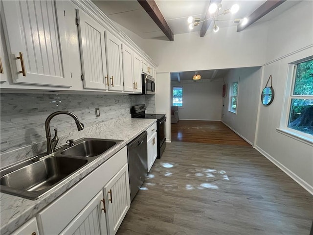 kitchen featuring white cabinets, a sink, backsplash, dark wood-type flooring, and appliances with stainless steel finishes