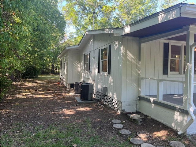 view of side of home featuring central AC unit