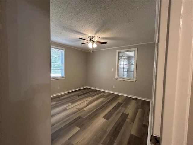unfurnished room featuring ornamental molding, baseboards, dark wood-style floors, a textured ceiling, and a ceiling fan