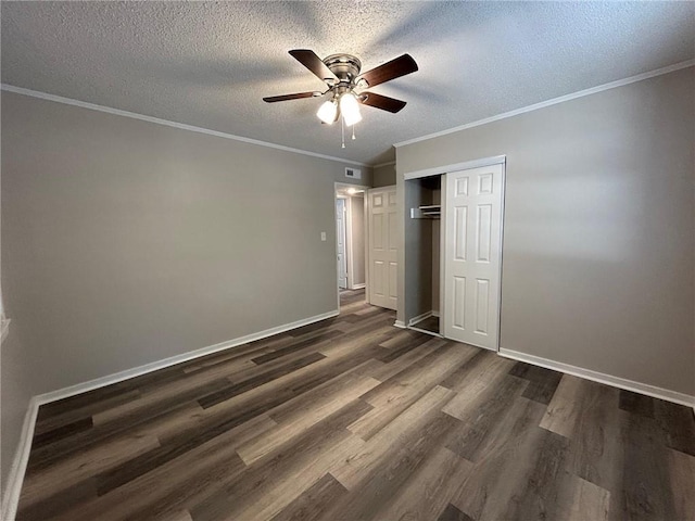 unfurnished bedroom with a closet, crown molding, dark wood-style flooring, visible vents, and a textured ceiling