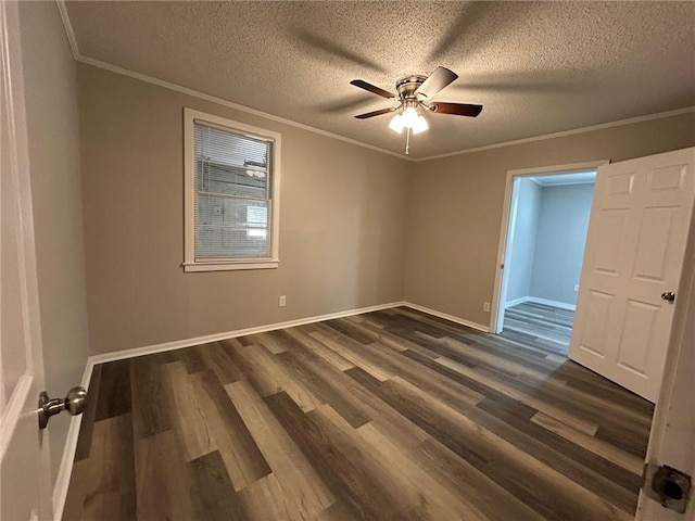 empty room featuring ornamental molding, a ceiling fan, dark wood-style flooring, and a textured ceiling