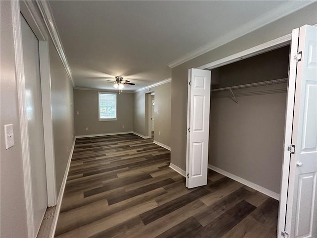 unfurnished bedroom with baseboards, ornamental molding, a ceiling fan, and dark wood-style floors