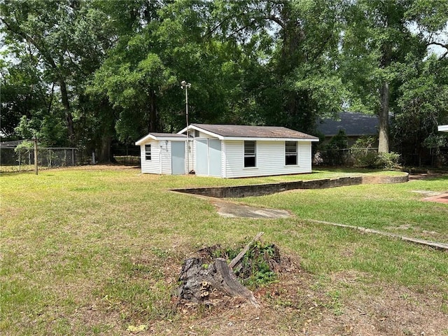 view of yard with fence and an outbuilding