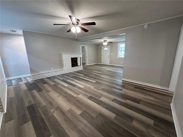 unfurnished living room with a ceiling fan, dark wood finished floors, visible vents, and a fireplace