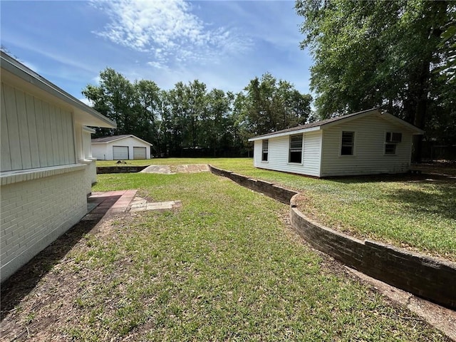 view of yard with an outdoor structure and a garage