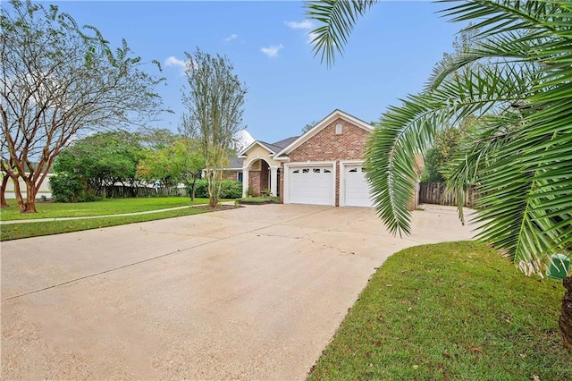 view of front of house with a garage and a front lawn