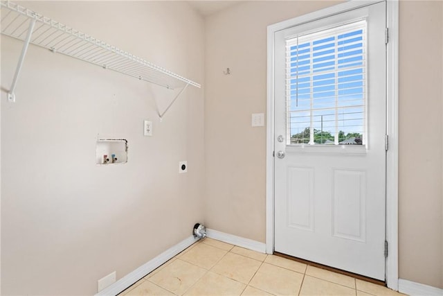 10966 Brighton Dr W, Chunchula, AL 36521 - laundry room with hookup for an electric dryer, hookup for a washing machine, baseboards, and light tile patterned floors